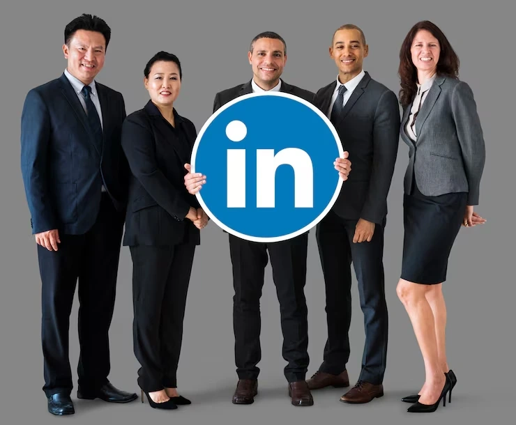 Five professionals holding a LinkedIn logo sign